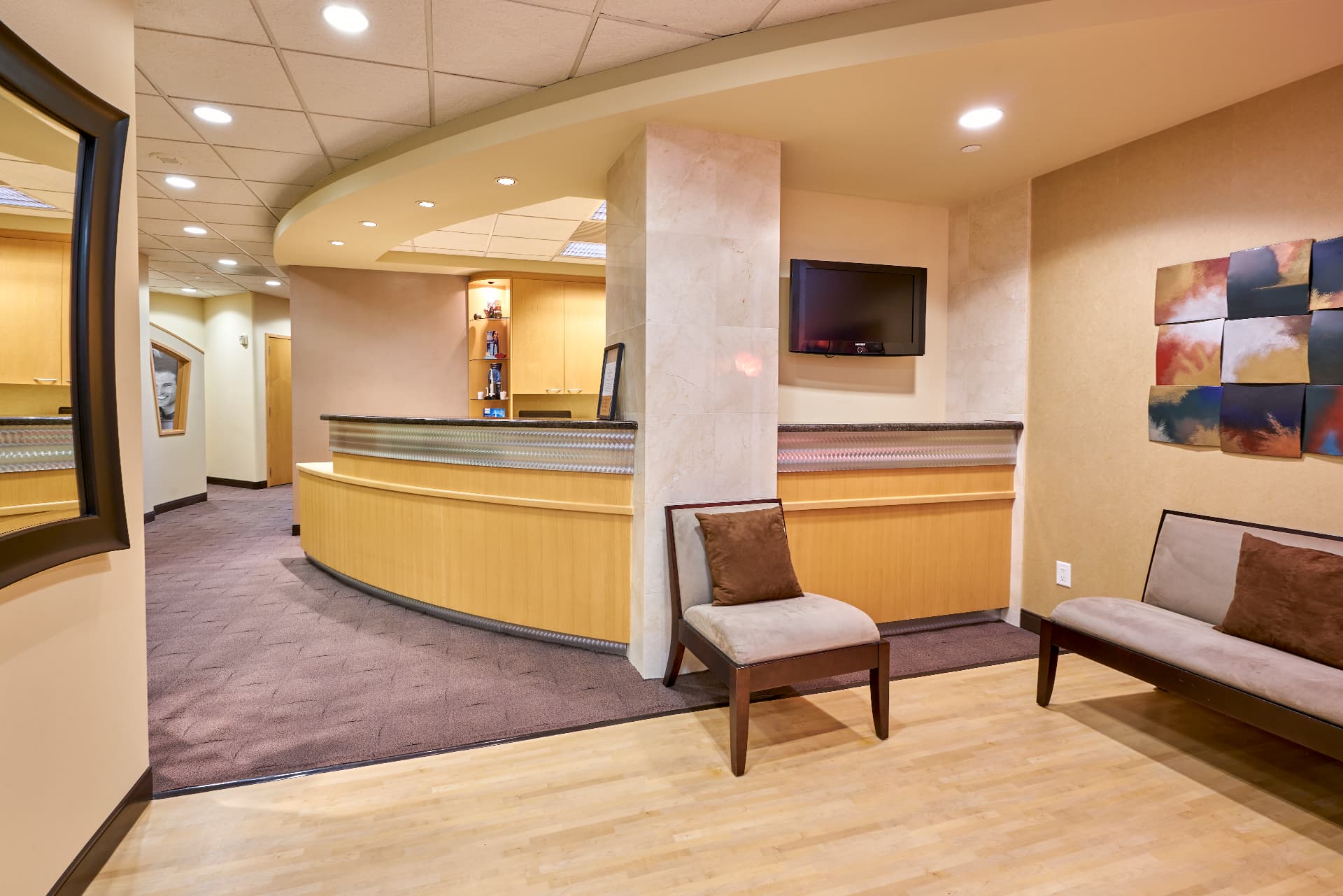 Reception lobby and curved check-in counter at Uptown Dentistry Suite 730 in Houston