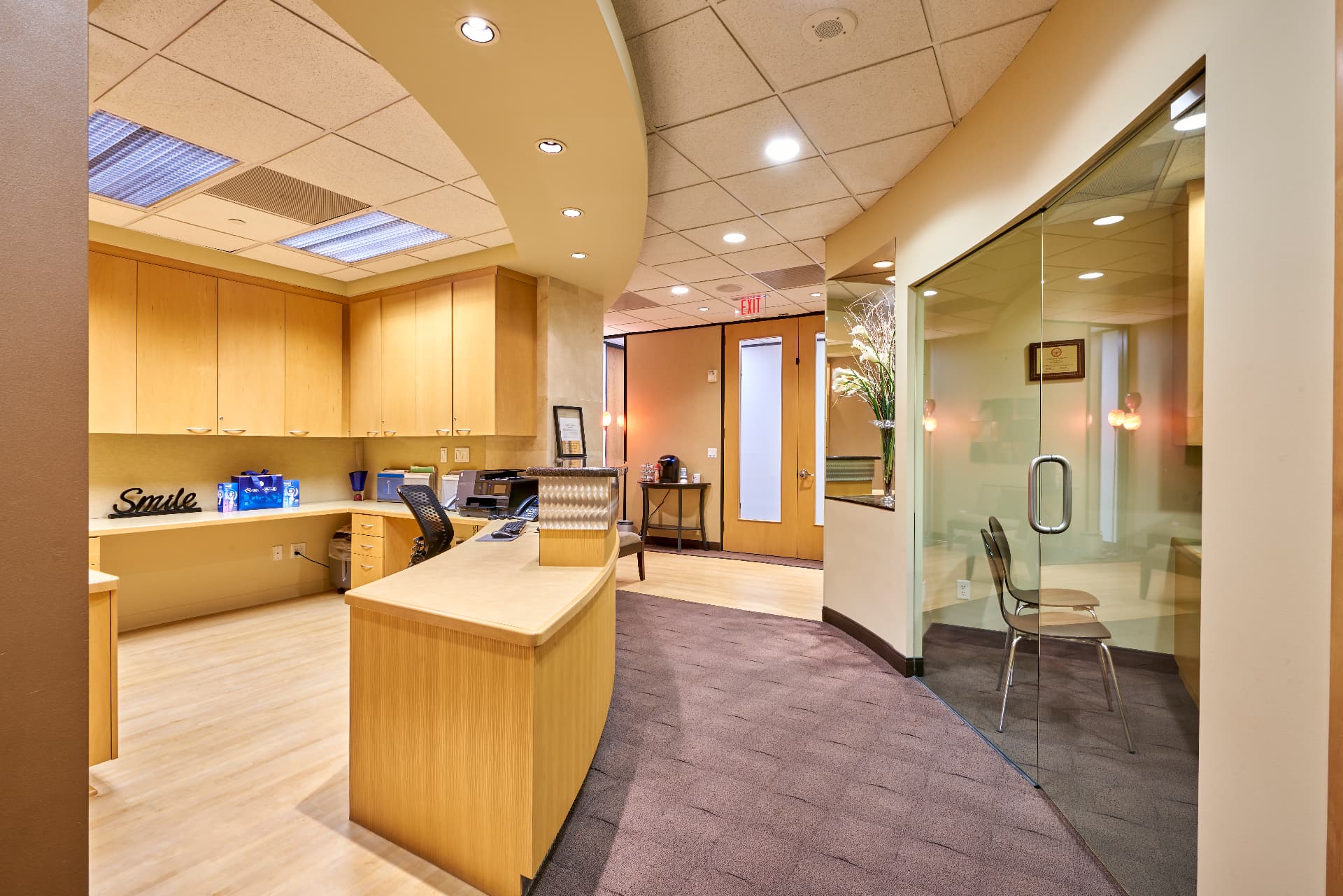 Business office and check-in desk at Uptown Dentistry, with the consultation room beyond